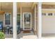 Charming front porch with rocking chairs, leading to the inviting front door and attached garage at 100 Beaconwood Ln, Holly Springs, NC 27540