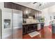Stylish kitchen featuring dark cabinets, stainless steel appliances, and ample counter space at 100 Beaconwood Ln, Holly Springs, NC 27540