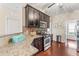 Updated kitchen featuring stainless steel appliances, granite counters, and dark wood cabinetry at 100 Beaconwood Ln, Holly Springs, NC 27540