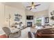 Spacious living room with a fireplace, vaulted ceilings, and a sliding door to the outside at 100 Beaconwood Ln, Holly Springs, NC 27540