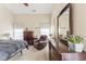Main bedroom offers comfort with a vaulted ceiling, sheer curtains, and rich wood furniture accents at 100 Beaconwood Ln, Holly Springs, NC 27540