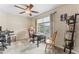 This is a comfortable office space with a ceiling fan, a window with blinds, and a black bookshelf at 100 Beaconwood Ln, Holly Springs, NC 27540