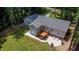 Aerial view of house with detached garage, patio, and deck at 1006 Oxford Ridge Rd, Wake Forest, NC 27587