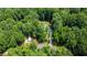 An aerial perspective showing a home with a long driveway surrounded by abundant trees, offering privacy and a natural setting at 1006 Oxford Ridge Rd, Wake Forest, NC 27587