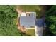 Aerial shot of home and detached garage, highlighting the backyard patio and surrounding green space from an elevated perspective at 1006 Oxford Ridge Rd, Wake Forest, NC 27587