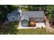 Aerial view of house with detached garage, patio, and deck at 1006 Oxford Ridge Rd, Wake Forest, NC 27587