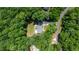 The aerial view displays a house encircled by towering trees, ensuring seclusion and a picturesque environment at 1006 Oxford Ridge Rd, Wake Forest, NC 27587