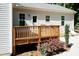 Back deck and lawn featuring wooden railing with a patio and greenery in the yard at 1006 Oxford Ridge Rd, Wake Forest, NC 27587