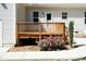 Back deck featuring wooden railing with a patio and greenery in the yard at 1006 Oxford Ridge Rd, Wake Forest, NC 27587