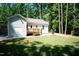 Backyard with a patio, deck, grassy area, and mature trees providing privacy at 1006 Oxford Ridge Rd, Wake Forest, NC 27587