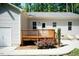 Exterior view of a backyard deck with wooden railing and mature trees at 1006 Oxford Ridge Rd, Wake Forest, NC 27587