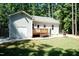 Charming backyard with a wooden deck, stone patio and beautiful landscaping at 1006 Oxford Ridge Rd, Wake Forest, NC 27587