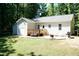 Home's backyard featuring a patio, deck, lawn, and mature landscaping at 1006 Oxford Ridge Rd, Wake Forest, NC 27587