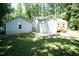 An open backyard, with a well-manicured lawn and back view of the house at 1006 Oxford Ridge Rd, Wake Forest, NC 27587
