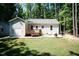 Home's backyard featuring a patio, deck, lawn and well landscaped yard at 1006 Oxford Ridge Rd, Wake Forest, NC 27587