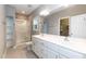 Bathroom with double vanity, large mirror, and glass-enclosed shower at 1006 Oxford Ridge Rd, Wake Forest, NC 27587
