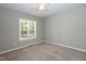Bedroom with plush carpet, ceiling fan and a large window at 1006 Oxford Ridge Rd, Wake Forest, NC 27587
