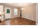 Dining area with hardwood floors, a chandelier, and access to the backyard at 1006 Oxford Ridge Rd, Wake Forest, NC 27587