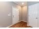 Bright entryway with hardwood floors, white door, and neutral-colored walls at 1006 Oxford Ridge Rd, Wake Forest, NC 27587