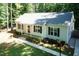 Single-story home featuring a detached garage, long driveway, and well-maintained landscaping at 1006 Oxford Ridge Rd, Wake Forest, NC 27587