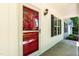 Charming front porch with red door, black shutters, and a decorative exterior light fixture at 1006 Oxford Ridge Rd, Wake Forest, NC 27587