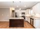 Modern kitchen featuring granite countertops, stainless steel appliances, and a functional island at 1006 Oxford Ridge Rd, Wake Forest, NC 27587