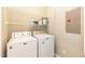 A laundry room with a white washer, dryer, and storage shelves above at 1006 Oxford Ridge Rd, Wake Forest, NC 27587