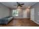 Bright living room featuring hardwood floors, crown molding, and a ceiling fan at 1006 Oxford Ridge Rd, Wake Forest, NC 27587