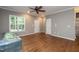 Neutral living room featuring hardwood floors, a ceiling fan, and natural light at 1006 Oxford Ridge Rd, Wake Forest, NC 27587