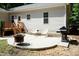 Backyard patio with fire pit, grill, and seating area at 1006 Oxford Ridge Rd, Wake Forest, NC 27587