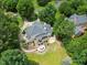 Aerial view of home with deck, patio and fire pit, nestled within a private wooded lot at 1009 Bentham Dr, Raleigh, NC 27614