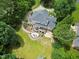 Sprawling backyard oasis with deck, patio, fire pit, seating area and lush green lawn at 1009 Bentham Dr, Raleigh, NC 27614