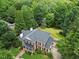 Aerial view of a grand home with lush landscaping and mature trees, providing privacy and beauty at 1009 Bentham Dr, Raleigh, NC 27614