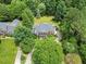 Majestic home surrounded by lush greenery, offering a private backyard with deck, patio, and fire pit for relaxation at 1009 Bentham Dr, Raleigh, NC 27614