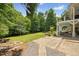 Expansive backyard featuring a covered patio, a lush green lawn, and mature trees at 1009 Bentham Dr, Raleigh, NC 27614