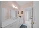 Bright bathroom features white cabinets, dual mirrors, and a shower with tub at 1009 Bentham Dr, Raleigh, NC 27614