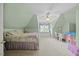 Inviting bedroom featuring soft green walls, carpet, a comfy bed, desk, and a fun window seat at 1009 Bentham Dr, Raleigh, NC 27614