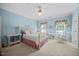 Comfortable bedroom featuring carpet, ceiling fan, and a cozy bed with a quaint desk and wicker chair at 1009 Bentham Dr, Raleigh, NC 27614