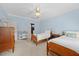 Light-filled bedroom with twin beds, wooden furniture, and ceiling fan at 1009 Bentham Dr, Raleigh, NC 27614