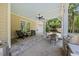 Charming covered patio with stone flooring, ceiling fan, and views of the landscaped backyard at 1009 Bentham Dr, Raleigh, NC 27614