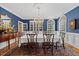Formal dining room with large windows, hardwood floors, and classic chandelier at 1009 Bentham Dr, Raleigh, NC 27614