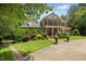 Well-maintained brick home with mature landscaping, lush lawn, and a circular driveway at 1009 Bentham Dr, Raleigh, NC 27614