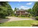 Charming two-story brick home surrounded by lush landscaping and a circular driveway at 1009 Bentham Dr, Raleigh, NC 27614