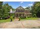 Attractive brick house with a well-kept lawn, featuring symmetrical design and classic architectural details at 1009 Bentham Dr, Raleigh, NC 27614