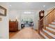 Foyer with hardwood floors, staircase, and view of the living room at 1009 Bentham Dr, Raleigh, NC 27614