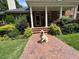 Beautiful brick home featuring manicured landscaping and a welcoming entrance with elegant columns at 1009 Bentham Dr, Raleigh, NC 27614