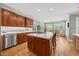 Spacious kitchen featuring a large island, wood cabinets, stainless steel appliances, and hardwood flooring at 1009 Bentham Dr, Raleigh, NC 27614