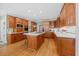 Open kitchen showcasing wood cabinetry, a center island, stainless appliances, and hardwood floors at 1009 Bentham Dr, Raleigh, NC 27614