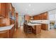 Bright kitchen boasting custom wood cabinetry, a center island with cooktop, and views into the entry hall at 1009 Bentham Dr, Raleigh, NC 27614