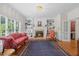 Bright living room with fireplace, custom built-ins, traditional furnishings, and windows overlooking the garden at 1009 Bentham Dr, Raleigh, NC 27614
